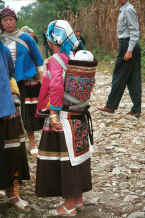 Jpeg 29K Side comb Miao women showing off their babies in beautifully decorated carriers - note the fine embroidery - Long Dong village, De Wo township, Longlin country, Guangxi province 0010d28.jpg