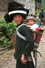 Jpeg 31K Side comb Miao woman and baby in their festival finery, Long Dong village, De Wo township, Longlin country, Guangxi province 0010d33.jpg