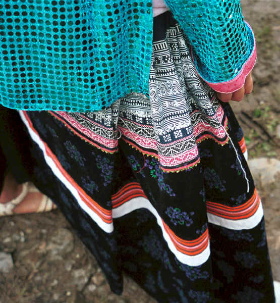 Close up of the top of a Side comb Miao woman's skirt showing the batik, embroidery inserts at the top and the strips of machine appliqu strips lower down - Long Dong village, De Wo township, Longlin country, Guangxi province 0010d35.jpg