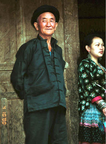 Side comb Miao man and woman outside the door to their home - Long Dong village, De Wo township, Longlin country, Guangxi province 0010e05.jpg