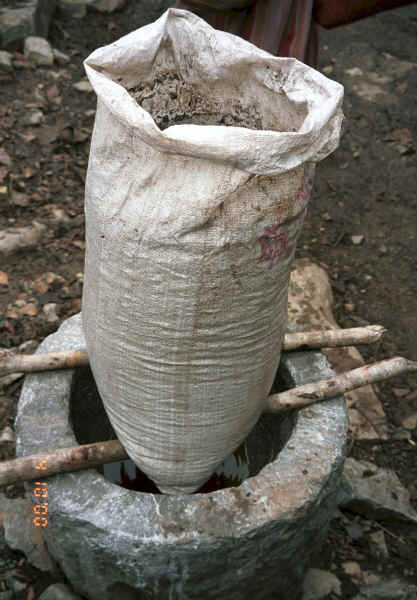 Water seeping through a bag of potash into a stone vessel prior to mixing up the indigo dye vat, Side comb Miao, Long Dong village, De Wo township, Longlin country, Guangxi province 0010e19.jpg