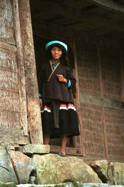 Side comb Miao woman at the doorway of her house - Long Dong village, De Wo township, Longlin country, Guangxi province 0010e27.jpg