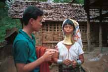 Jpeg 54K Thai guide offering anti-malaria tablets to Padaung woman 8812j02