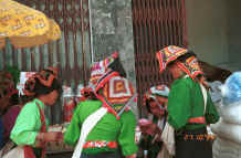 to Photo gallery 29K This photo - BlackThai women examining goods for sale in Ban Vay market on the road from Son La to Dien Bien Phu in Son La Province showing off their embroidered head cloths 9510C21.JPG